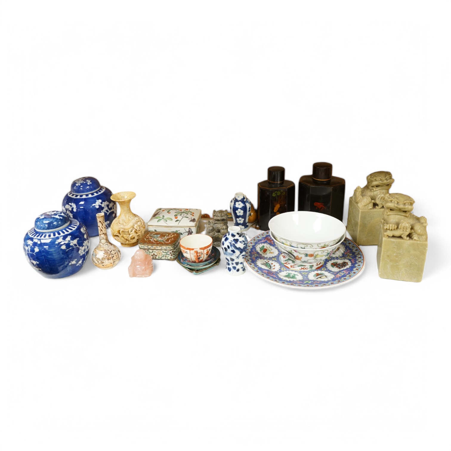 A group of mixed Chinese and Japanese ceramics to include soapstone carvings, prunus flower ginger jars, rose quartz Buddha and pair of famille rose bowls. Condition - varies, mostly fair/good